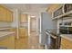 This kitchen features wooden cabinets, stainless steel appliances, and a view to the front entrance of the home at 115 Sunderland Cir, Fayetteville, GA 30215