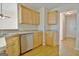 This kitchen features wooden cabinets, stainless steel appliances, and a view to the front entrance of the home at 115 Sunderland Cir, Fayetteville, GA 30215