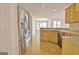 This kitchen features wooden cabinets, stainless steel appliances, and a view of the living room at 115 Sunderland Cir, Fayetteville, GA 30215