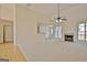 Open living room featuring a fireplace, ceiling fan, and large windows for ample natural light at 115 Sunderland Cir, Fayetteville, GA 30215