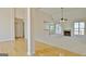 Open living room showcasing a fireplace, ceiling fan, and large windows for ample natural light at 115 Sunderland Cir, Fayetteville, GA 30215
