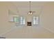 Spacious living room with a fireplace, large windows, neutral carpet and a ceiling fan at 115 Sunderland Cir, Fayetteville, GA 30215