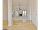 Open living room with wood floors, fireplace, and abundant natural light at 115 Sunderland Cir, Fayetteville, GA 30215