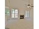 Spacious living room with a fireplace, large windows, neutral carpet and a ceiling fan at 115 Sunderland Cir, Fayetteville, GA 30215
