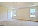 This main bedroom is spacious, with carpet flooring, neutral walls, and a ceiling fan at 115 Sunderland Cir, Fayetteville, GA 30215