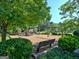 Community playground surrounded by lush trees with mulch ground at 115 Sunderland Cir, Fayetteville, GA 30215