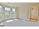 Bright, airy room featuring neutral carpet and lots of natural light from large windows and french doors at 115 Sunderland Cir, Fayetteville, GA 30215