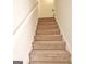 A carpeted staircase leads to the upper level of the home at 115 Sunderland Cir, Fayetteville, GA 30215