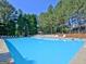Large, refreshing community swimming pool with ample lounge seating and a serene, treelined backdrop at 115 Sunderland Cir, Fayetteville, GA 30215