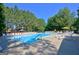 Beautiful community swimming pool with lounge chairs and trees in the background at 115 Sunderland Cir, Fayetteville, GA 30215