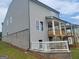 The back of a gray home showing the deck and a white fence barrier at 38 Avian Way # 126B, Auburn, GA 30011