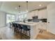 Open-concept kitchen with an island, bar seating, and an adjacent dining area flooded with natural light at 38 Avian Way # 126B, Auburn, GA 30011
