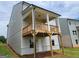 View of back porch with wood columns and a wood railing overlooking the backyard at 40 Avian Way # 127B, Auburn, GA 30011