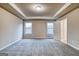 Bedroom with tray ceilings, neutral carpet, two windows and ensuite access at 40 Avian Way # 127B, Auburn, GA 30011