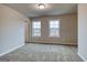 This bedroom has plush carpet, neutral walls, and two windows allowing natural light at 40 Avian Way # 127B, Auburn, GA 30011