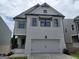 Charming two-story home featuring a painted brick facade, a two-car garage, and stylish shutters at 40 Avian Way # 127B, Auburn, GA 30011