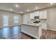 Modern kitchen with stainless appliances and eat in island with granite counters at 40 Avian Way # 127B, Auburn, GA 30011
