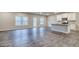 Open-concept living area features kitchen with island, wood floors, and windows at 40 Avian Way # 127B, Auburn, GA 30011