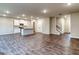 Open-concept living area featuring wood floors, a kitchen, a staircase, and recessed lighting at 40 Avian Way # 127B, Auburn, GA 30011