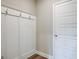 This mudroom features paneled walls with hooks and lovely hardwood floors at 40 Avian Way # 127B, Auburn, GA 30011