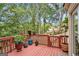 Inviting backyard deck with potted plants and serene view of a backyard with lush trees at 1911 Geyser Trce, Lawrenceville, GA 30044