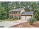 Lovely brick house with black shutters, mature trees, and a two-car garage at 1911 Geyser Trce, Lawrenceville, GA 30044