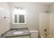 Bathroom featuring a granite countertop, a white sink, and a shower at 11102 Hunters Ln, Hampton, GA 30228