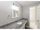 Bathroom featuring a granite countertop with a white sink and tile flooring at 11102 Hunters Ln, Hampton, GA 30228
