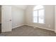 Bedroom featuring a large window for natural light and neutral carpeting at 11102 Hunters Ln, Hampton, GA 30228