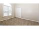 Bedroom featuring a large window for natural light and neutral carpeting at 11102 Hunters Ln, Hampton, GA 30228