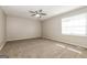 Bedroom with neutral walls and carpeting, featuring a ceiling fan and a window at 11102 Hunters Ln, Hampton, GA 30228