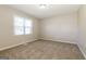 Bedroom with neutral walls and carpeting, featuring a large window at 11102 Hunters Ln, Hampton, GA 30228