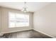 Inviting dining area with large window, neutral walls, and stylish gray floors at 11102 Hunters Ln, Hampton, GA 30228