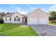 Charming single-story home with a well-maintained lawn and two-car garage at 11102 Hunters Ln, Hampton, GA 30228