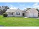 Well-kept single-story home with a lush green lawn and a welcoming facade at 11102 Hunters Ln, Hampton, GA 30228