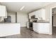 Well-lit kitchen with white cabinets, stainless steel appliances, and granite countertops at 11102 Hunters Ln, Hampton, GA 30228