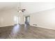 Bright living room featuring vaulted ceiling, neutral walls, and modern gray floors at 11102 Hunters Ln, Hampton, GA 30228