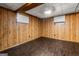 Finished basement showcasing wood-paneled walls and updated vinyl flooring at 115 Club Cir, Stockbridge, GA 30281