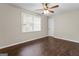 Bedroom features dark vinyl wood floors, neutral paint, one window and a ceiling fan at 115 Club Cir, Stockbridge, GA 30281