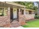 Home entrance with a brick porch, stylish pineapple decor, and stone exterior accents at 115 Club Cir, Stockbridge, GA 30281