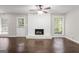 Cozy living room featuring a classic white brick fireplace and large windows at 115 Club Cir, Stockbridge, GA 30281