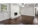 Comfortable living room featuring a white brick fireplace and access to the hallway at 115 Club Cir, Stockbridge, GA 30281