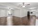 Open-concept living room with hardwood floors, connecting to the kitchen and outdoor access at 115 Club Cir, Stockbridge, GA 30281