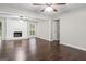 Spacious living room with hardwood floors and a traditional white brick fireplace at 115 Club Cir, Stockbridge, GA 30281