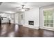 Inviting living room with hardwood floors, a white brick fireplace, and a view of the kitchen at 115 Club Cir, Stockbridge, GA 30281