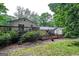 A lush backyard features a wooden deck and mature trees at 2031 Dennis Pl, Buford, GA 30519