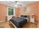 Cozy bedroom with hardwood floors, a ceiling fan, and a white writing desk by the window at 2031 Dennis Pl, Buford, GA 30519