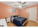 Cozy bedroom with hardwood floors, a ceiling fan, and a white nightstand with a lamp at 2031 Dennis Pl, Buford, GA 30519