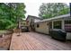 The wooden deck extends along the back of the house and overlooks the trees at 2031 Dennis Pl, Buford, GA 30519