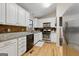 Well-lit kitchen with white cabinets, stainless steel appliances, and granite countertops at 2031 Dennis Pl, Buford, GA 30519